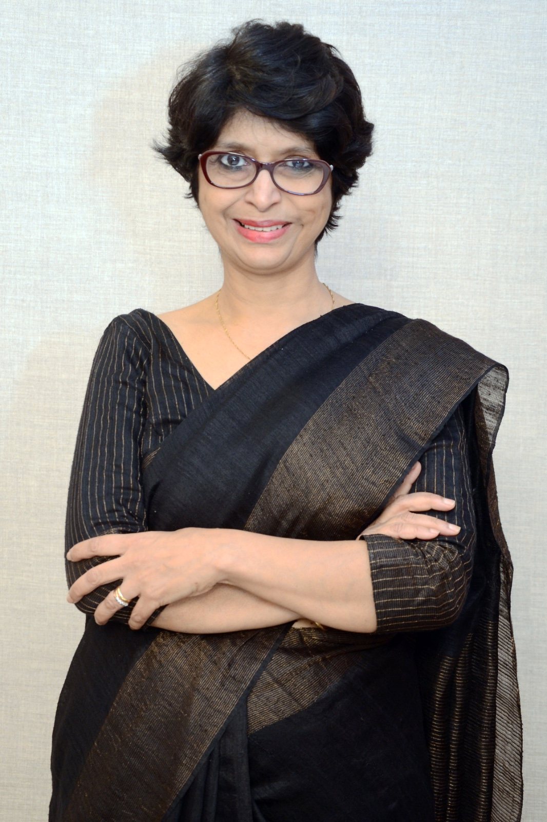 Ruth Singh, executive and leadership coach, in a black and gold saree
